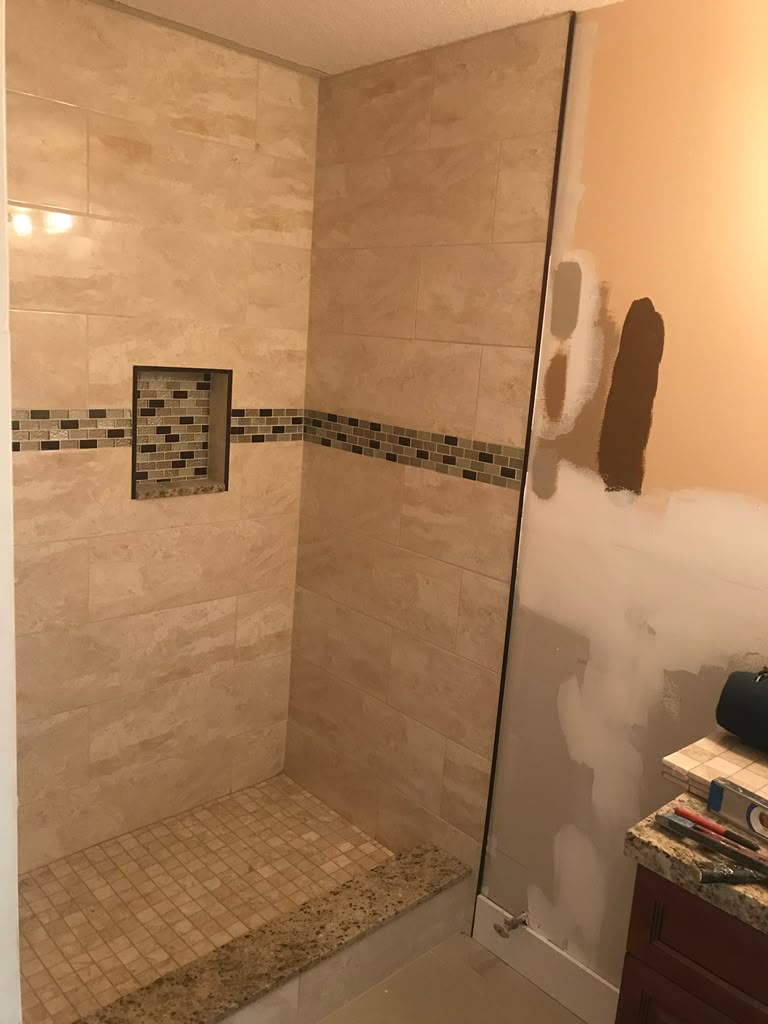 Walk-in shower with mosaic accent and niche