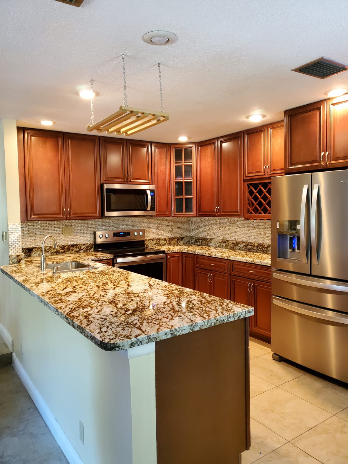 Rich wood kitchen with granite surfaces